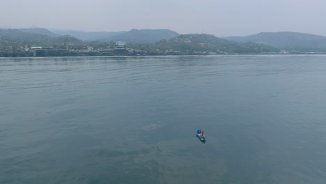 Aerial-Drone-view-of-Small-Fishing-Boat-at-Sea-El-Tunco-El-Salvador