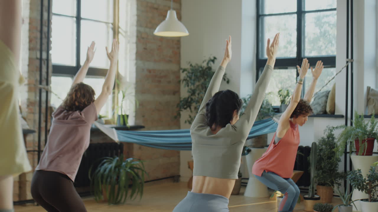 Group of Women Practicing Yoga in a Bright Studio