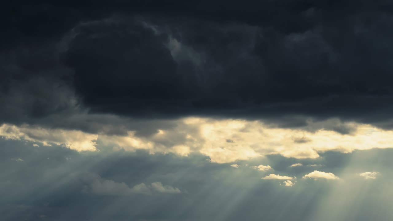 dramatic sunset sky time lapse, bright sunlight and dark silhouette of clouds as a background, extreme weather