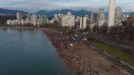 Various-drone-shots-at-English-Bay-near-downtown-Vancouver,-BC-during-Polar-Bear-2019-event