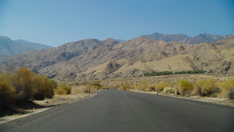 palm springs empty road low pov with the rugged san jacinto mountains rising behind them in california