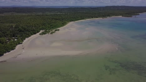 A-mesmerizing-scene-emerges-at-the-Natural-Pools-of-Barra-de-Lagoa-in-Morro-de-Sao-Paulo,-Bahia,-Brazil,-with-captivating-white-sands-and-lush-green-trees,-creating-a-serene-atmosphere