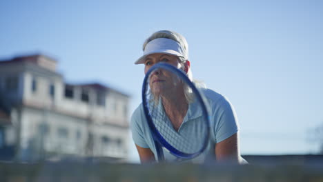 senior woman playing tennis