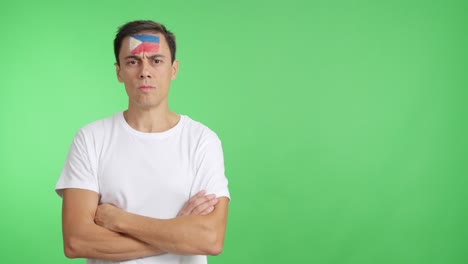 dignified and serious man with philippine flag painted on face