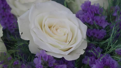 beautiful white rose bouquet with purple flowers