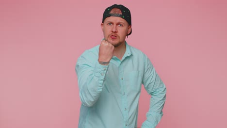 aggressive angry man trying to fight at camera shaking fist boxing with expression punishment