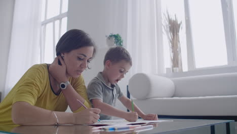 Young-Woman-And-Child-Drawing-Together-Making-Picture-With-Pencils-In-Flat