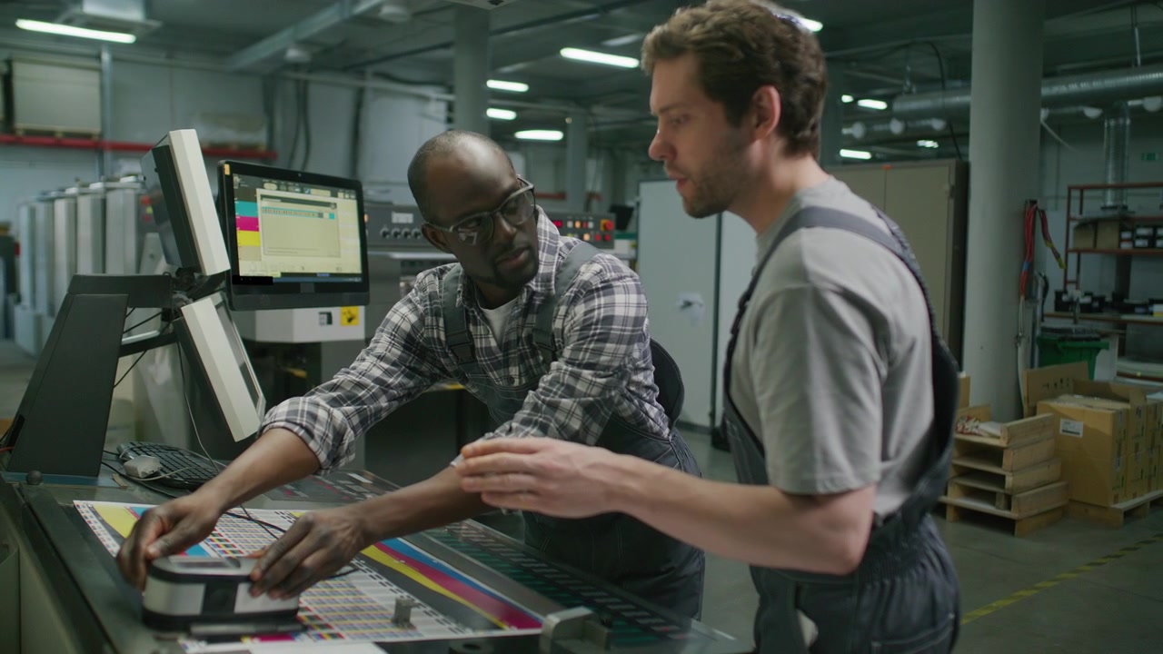 Printing Factory Workers Checking Color Quality on Industrial Press Machine