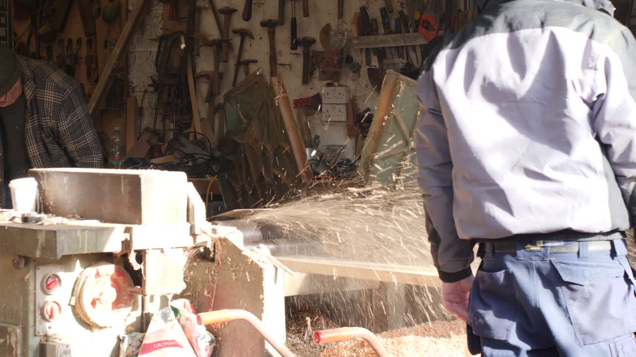 Planing Pine wood plank with industrial planer thicknesser