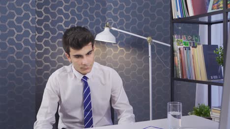 Businessman-is-drinking-water-standing-at-his-desk-and-is-stressed.