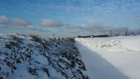 large amounts of snow form snow dunes in a ditch