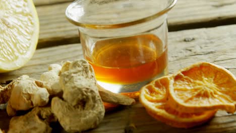 herbal tea with ginger and lemon on wooden table 4k