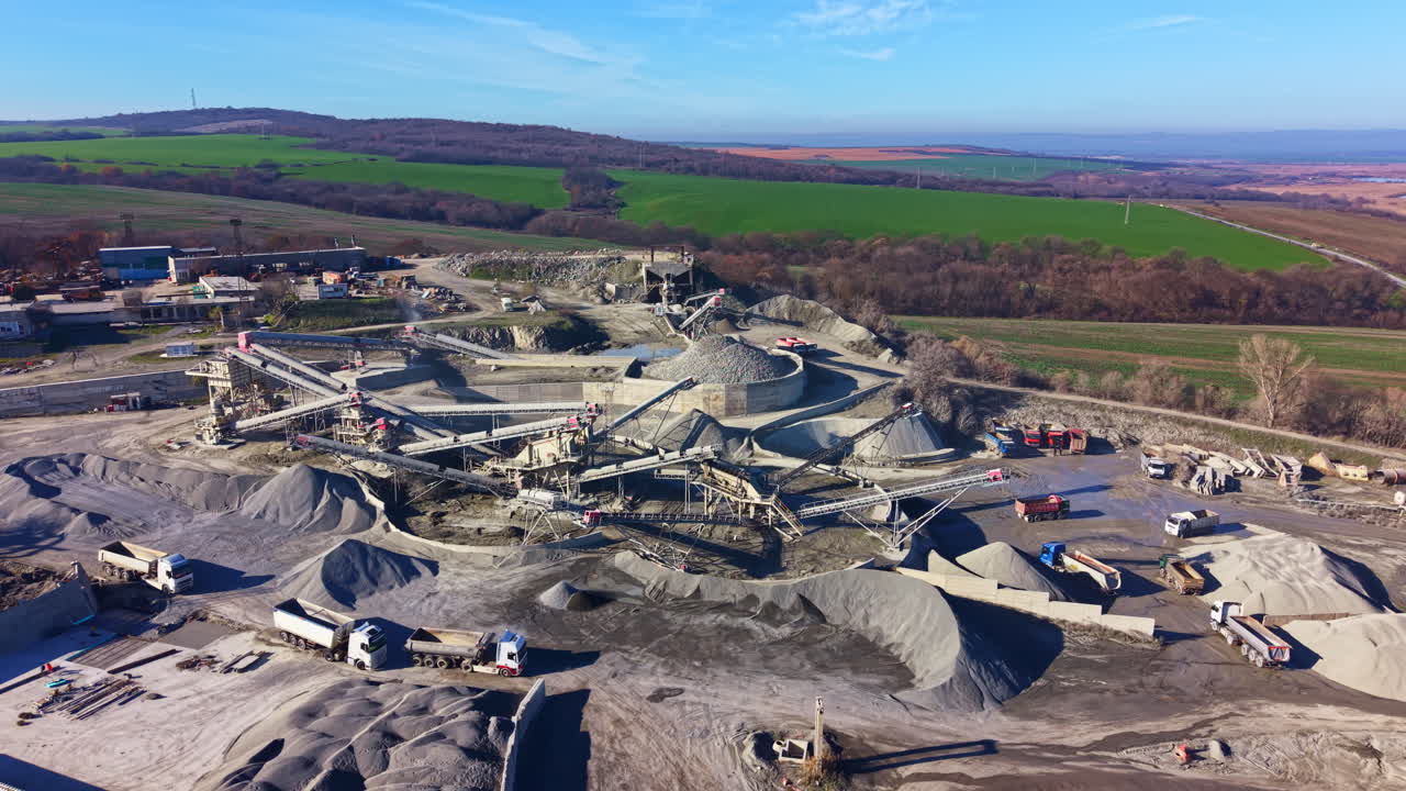 Intricate machinery at a stone quarry in the countryside, revealing nature's beauty amidst human activity during a clear day