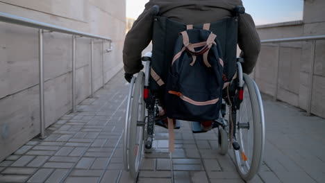 person in wheelchair using a ramp