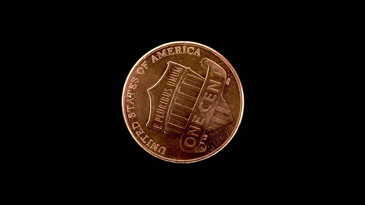 United States 2010 1 cent coin reverse with Union Shield rotating on black background