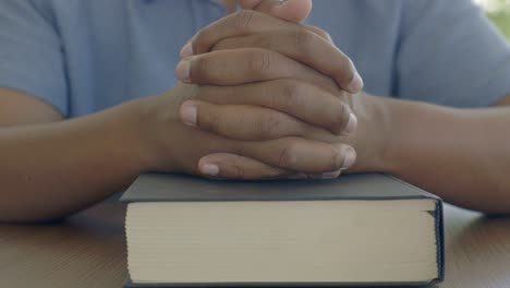 person praying with bible