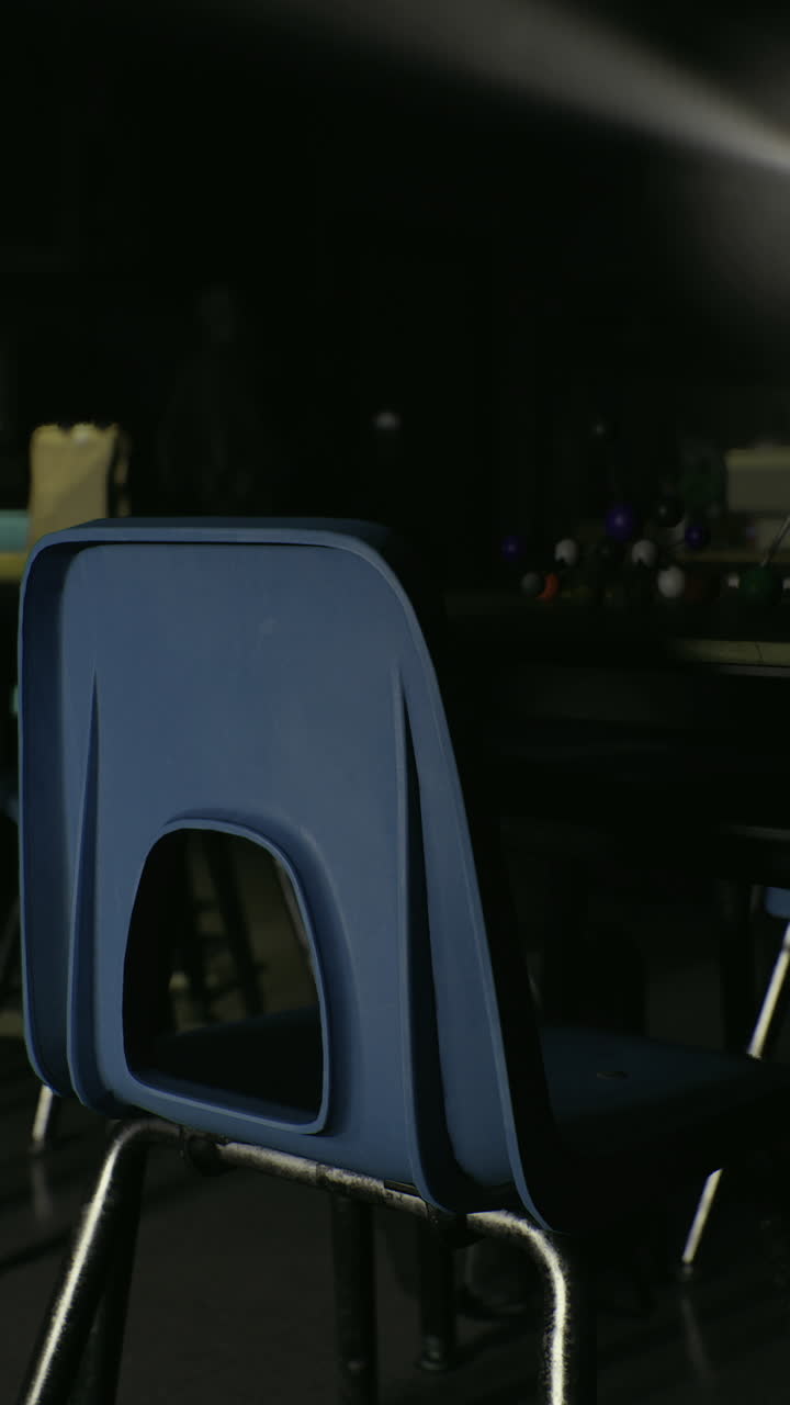 An individual sits on azure seat under shining stage illumination