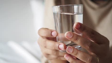 person holding a glass of water