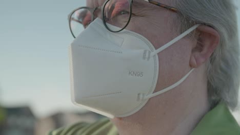 Close-up-of-man-wearing-KN95-mask-with-glasses