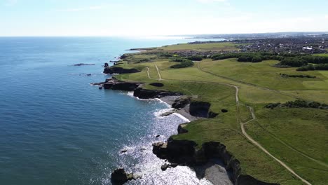 rising aerial shot of whitburn cliffs and north east coastline. sunderland, uk