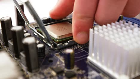 technician fixing chip on motherboard