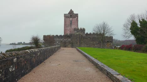 Doe-Castle-Against-Cloudy-Sky-In-Creeslough,-County-Donegal,-Ireland---Panning-Shot