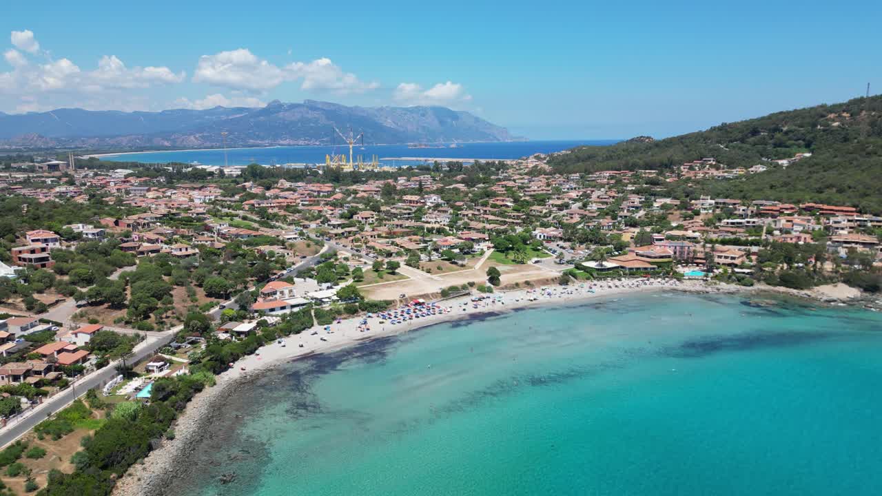 Arbatax Beach and Port in the background in Sardinia, Italy - Aerial 4k
