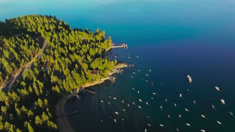 beautiful sunny morning on the lake tahoe. lots of boats and yachts standing on the anchor near the beautiful wooded shore. top view.