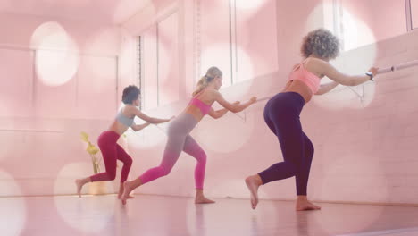 women exercising at barre in fitness studio with bokeh lights animation