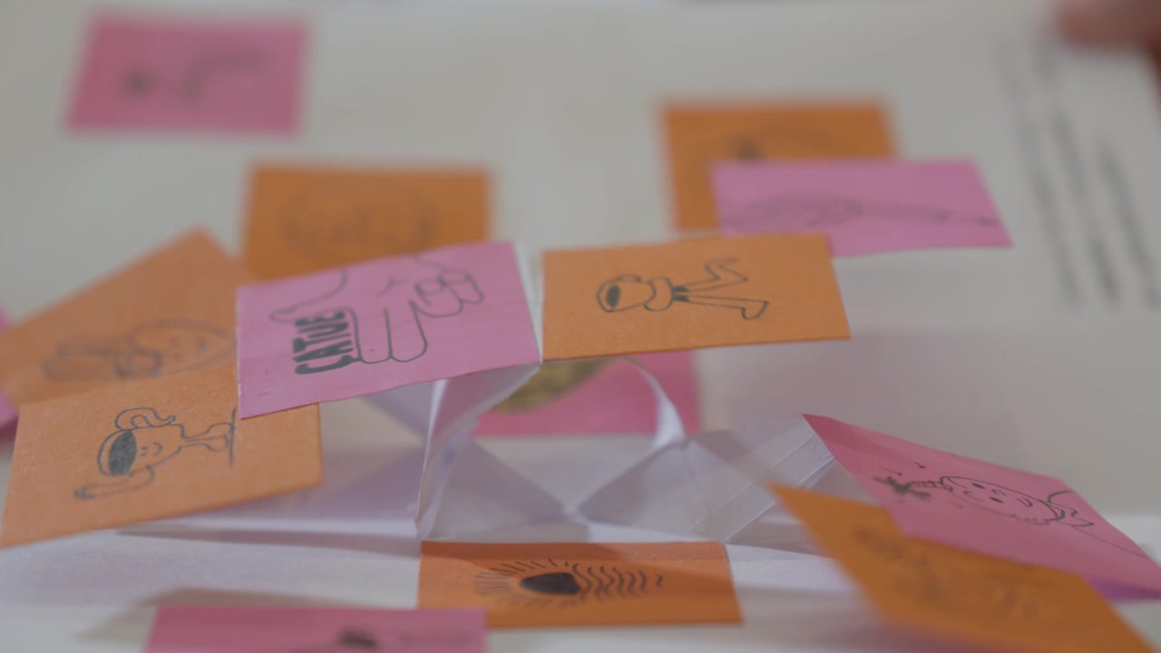 Static macro view reveals colorful tabs and folds inside a handmade pop up book.