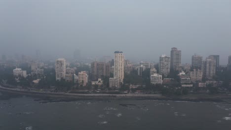 Slider-drone-shot-along-BJ-road-Bandra-Bandstand-high-tide-hazy-day