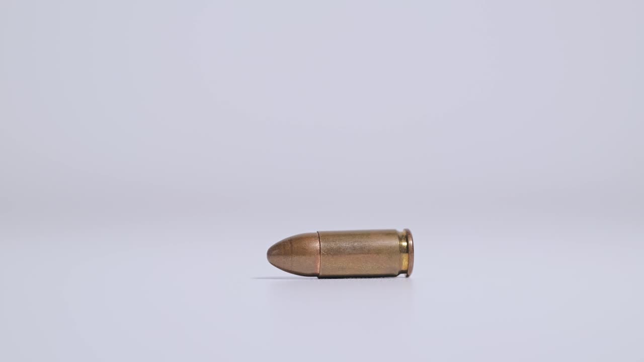 Slow motion shot of 9mm bullet choosing direction like pointer in fate metaphor