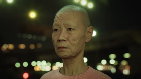 old-Asian-woman-in-city-at-night