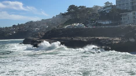 4K-Slow-motion-footage-of-large-ocean-wave-crashing-and-spraying-at-high-tide-in-La-Jolla-Cove-in-San-Diego,-California