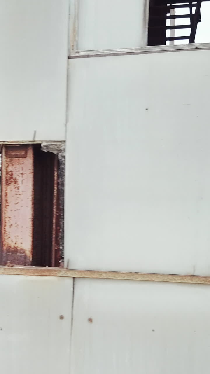 Drone flies over an abandoned factory. Old abandoned factory building. Aerial View. Vertical video