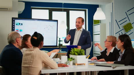 manager pointing on digital interactive whiteboard with growth analysis