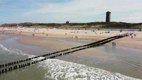 large lighthouse at a beach in the netherlands