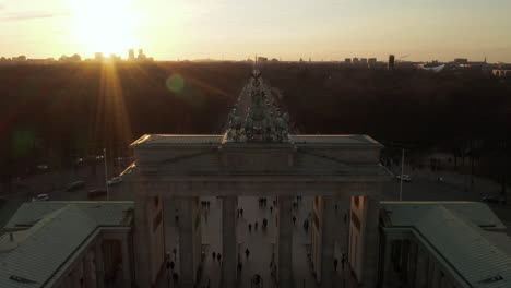 AERIAL:-Close-Up-of-Quadriga-Green-Statue-on-Brandenburger-Tor-in-Berlin,-Germany-in-beautiful-Sunset-light