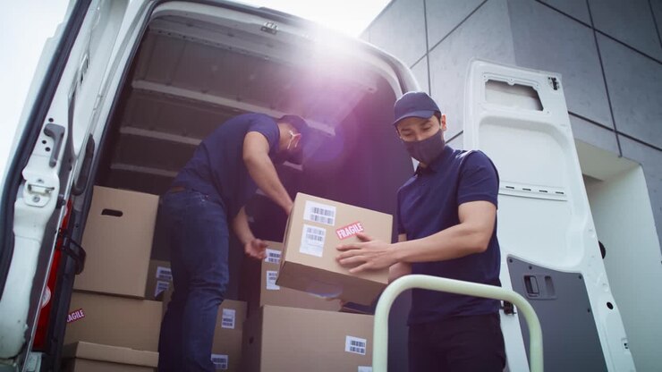 Bottom view of couriers unloading packages during a pandemic