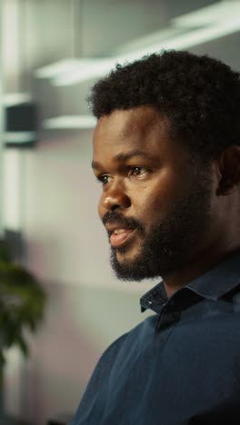 vertical video employee looking over revenue figures on documents in office