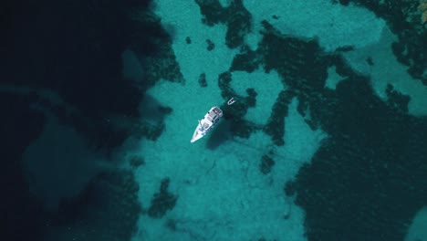 Yacht-ship-sailing-boat-at-pristine-turquoise-clear-water-beach-bay-on-Palma-de-Mallorca-Island