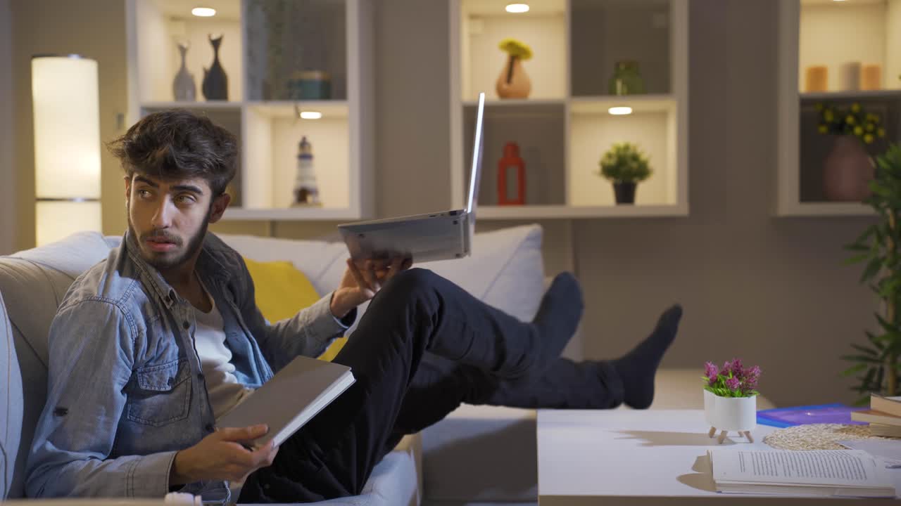 Man alone at night at home scared and looking around.