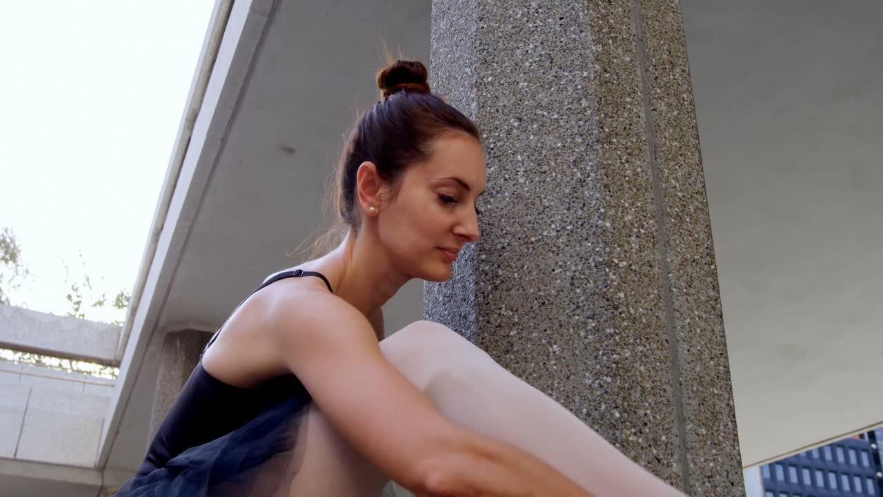 bailarina de ballet estirándose en el pilar 4k