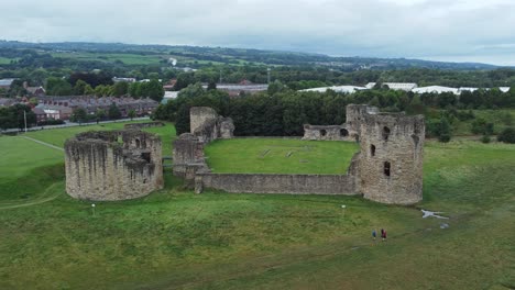 Flint-castle-Welsh-medieval-coastal-military-fortress-ruin-aerial-view-slow-orbiting-right