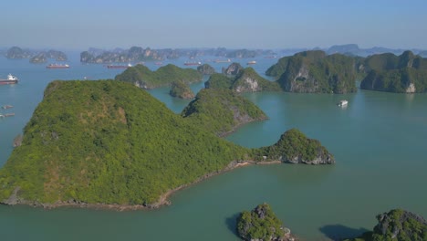 ha long bay scenic view of extreme waves splashing on the rugged cliff in vietnam - aerial drone