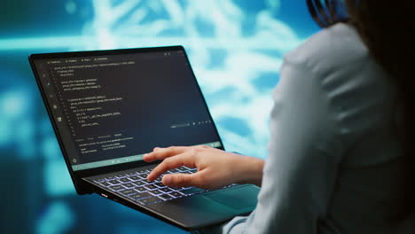 Close up shot of IT expert using AI system and laptop