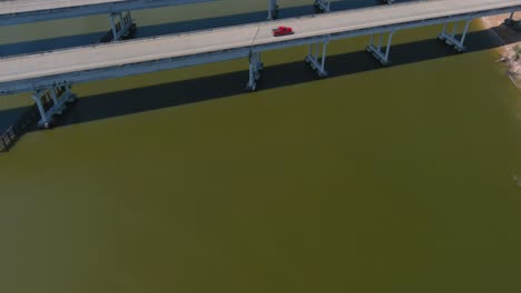 Aerial-of-cars-driving-on-bridge-that-crosses-over-the-San-Jacinto-River-in-Houston,-Texas