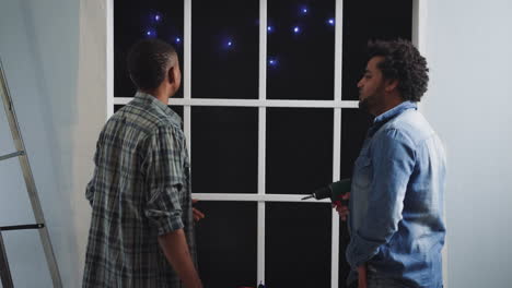 african-american builders talk and look at constellations