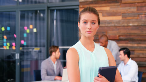portrait of business executive holding digital tablet
