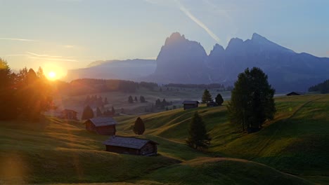 sunrise over the alps: breathtaking mountain landscape with wooden cabins